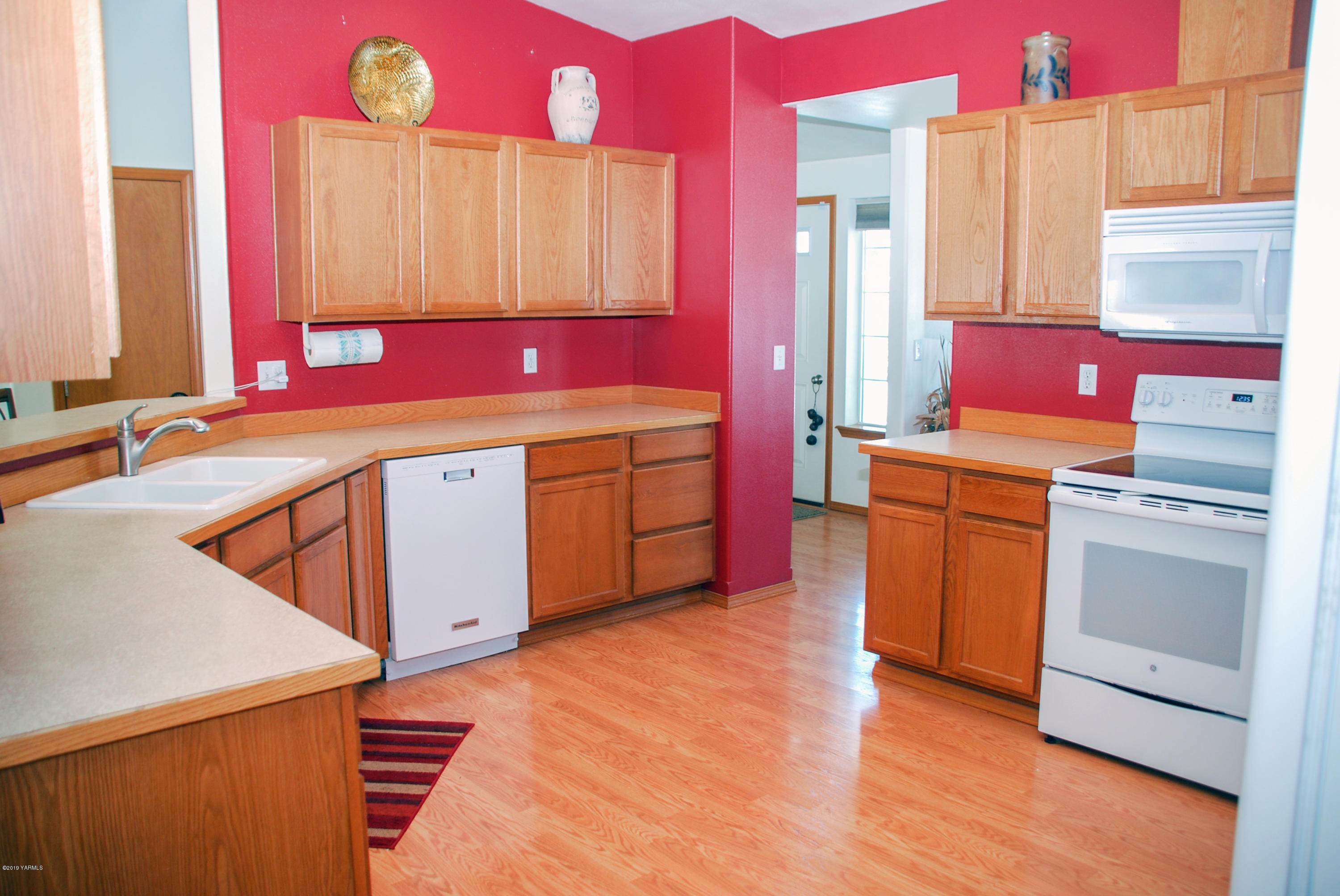 1271 North Granger Road Zillah, WA 98953 - Photo 9 of 30 a room with kitchen island granite countertop wooden cabinets a sink and a stove