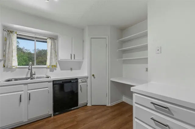 a kitchen with a sink and cabinets