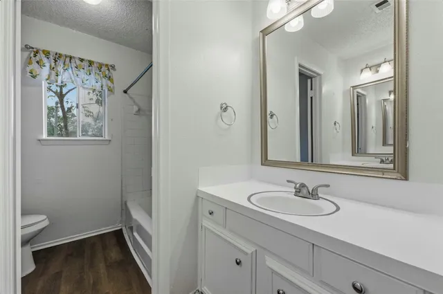 a bathroom with a sink a toilet a shower and a mirror