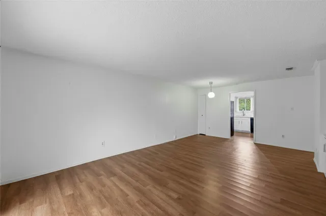 a view of an empty room and wooden floor