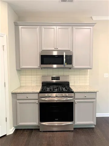 a stove top oven sitting inside of a kitchen