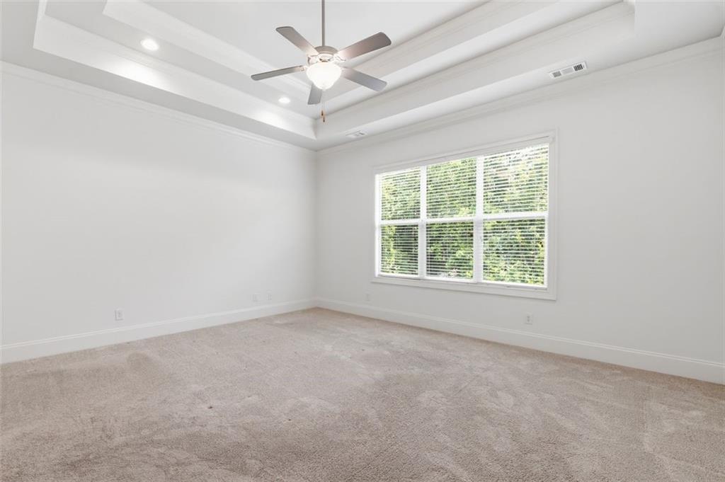 337 Rosshandler Road Suwanee, GA 30024 - Photo 21 of 45 an empty room with a chandelier fan and windows