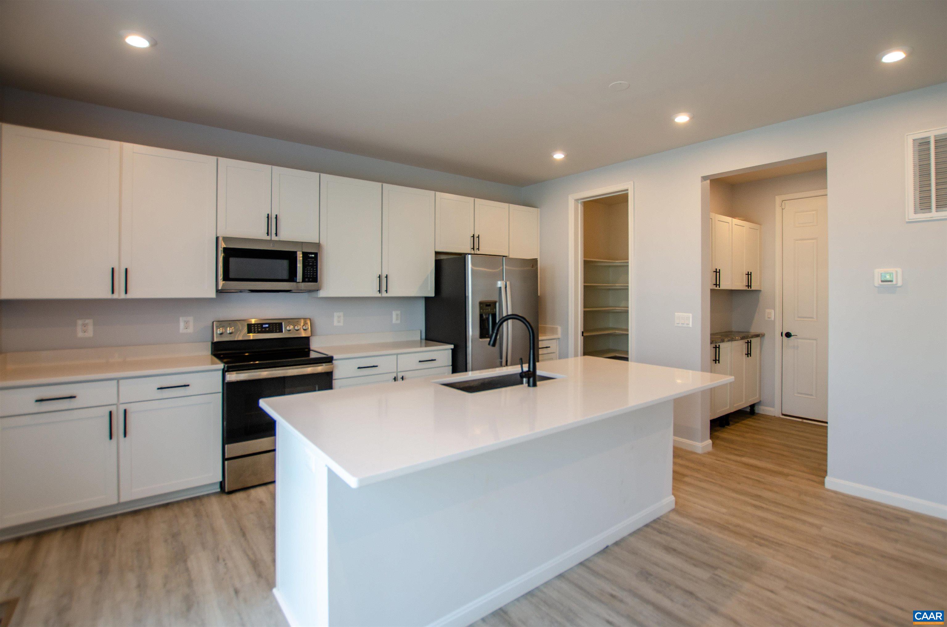 403 Meadows Drive Orange, VA 22960 - Photo 16 of 50 a kitchen with kitchen island a white counter top space stainless steel appliances and cabinets