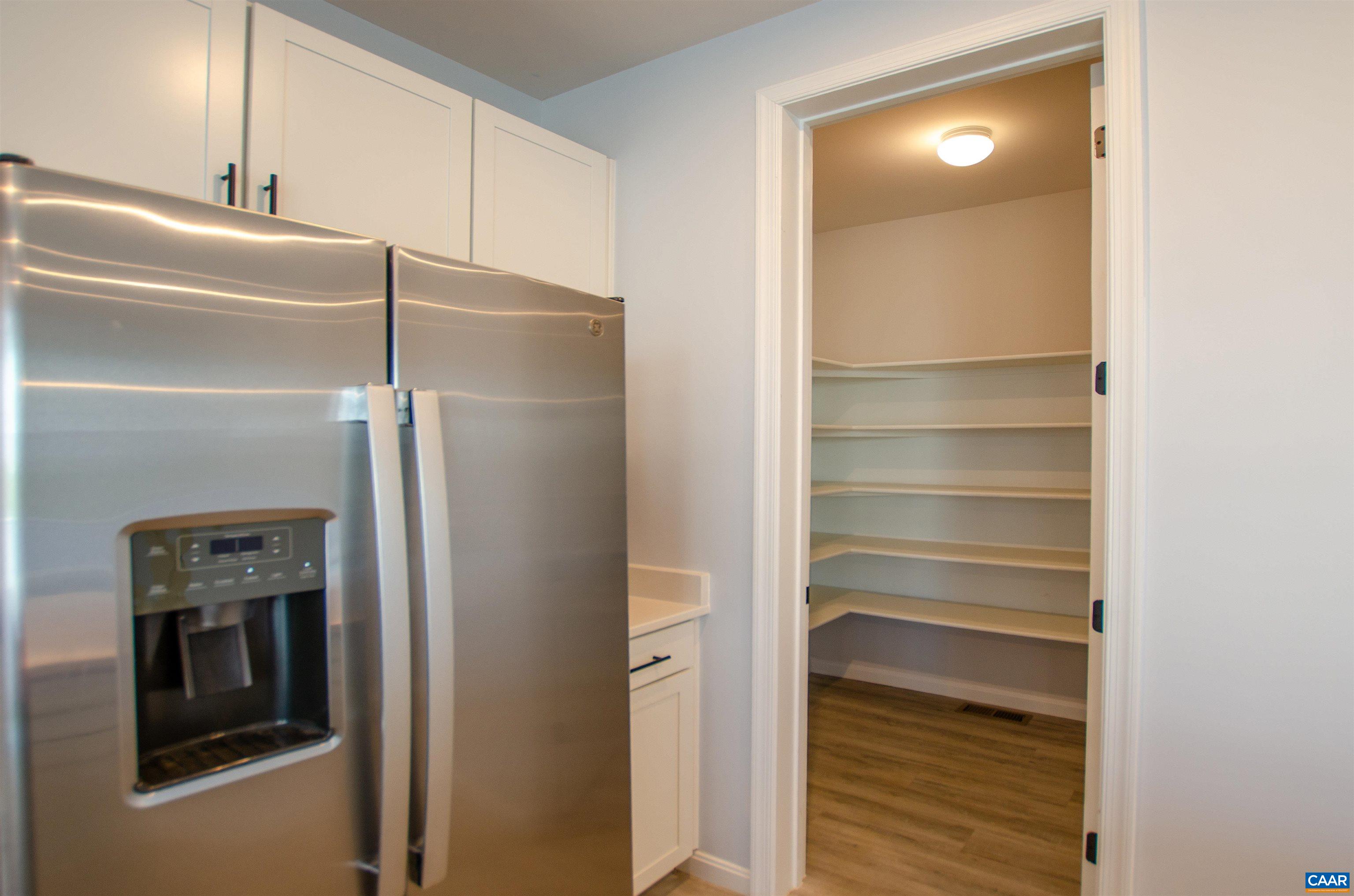 403 Meadows Drive Orange, VA 22960 - Photo 20 of 50 a kitchen with a refrigerator and a wooden floor