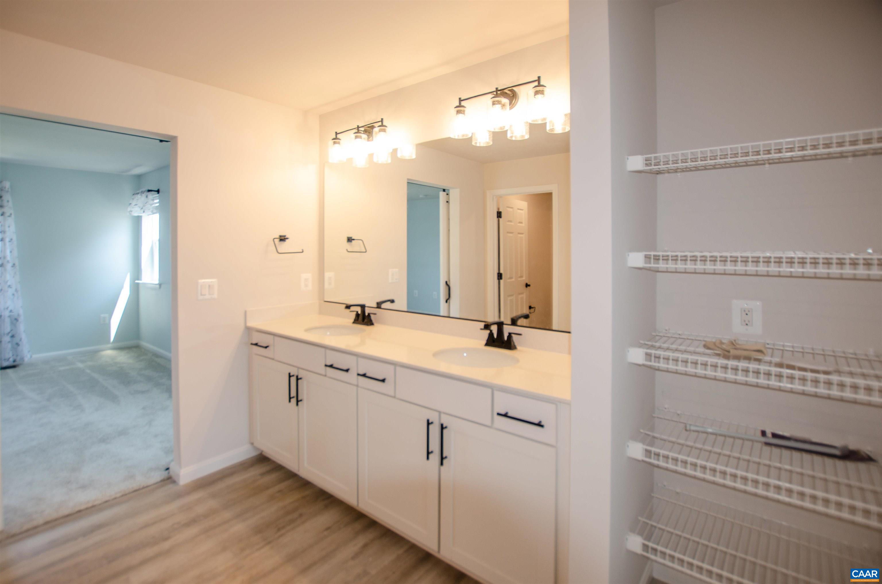 403 Meadows Drive Orange, VA 22960 - Photo 32 of 50 a bathroom with a double vanity sink and mirror