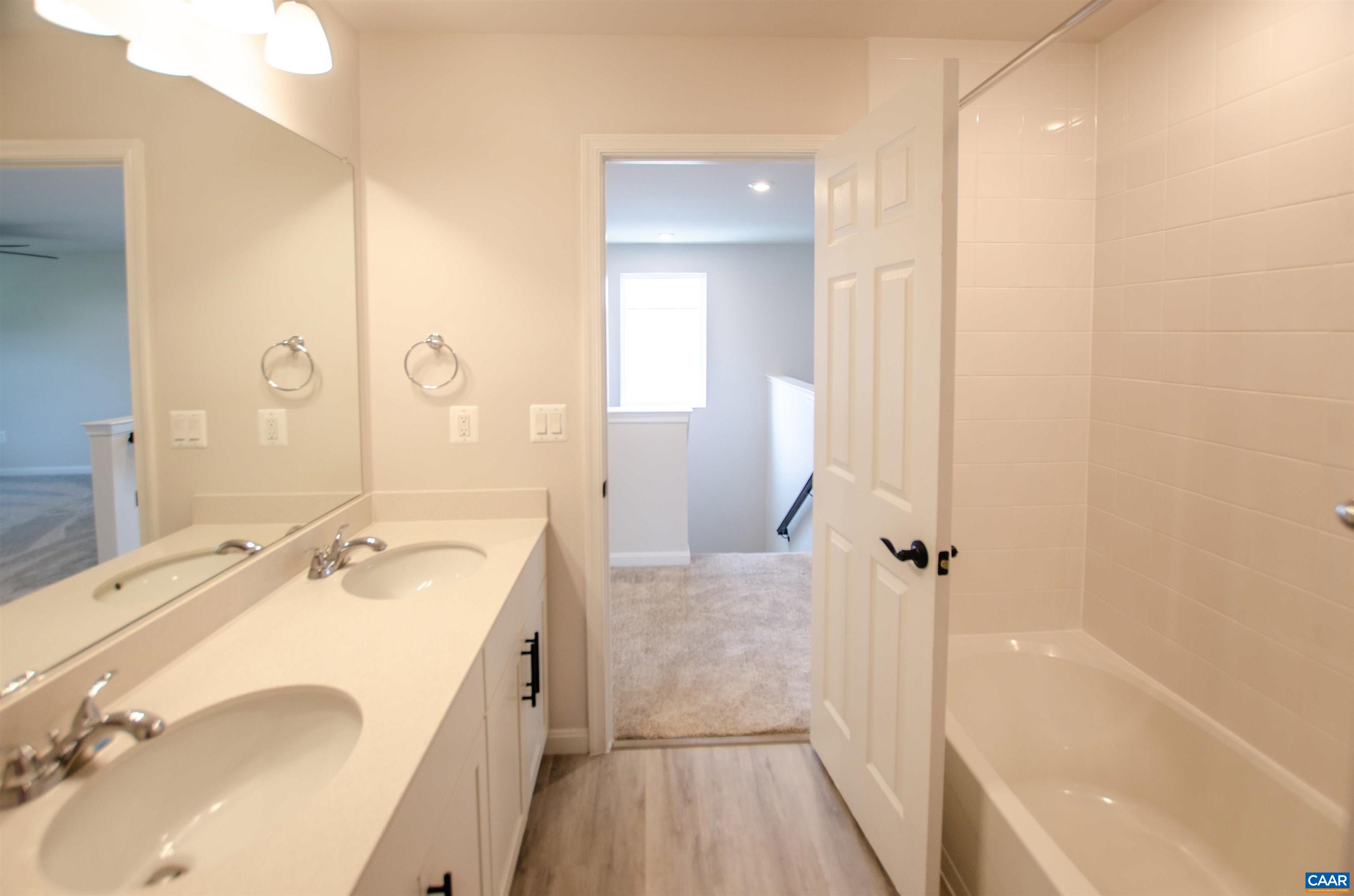 403 Meadows Drive Orange, VA 22960 - Photo 37 of 50 a bathroom with a granite countertop sink a mirror and a bathtub