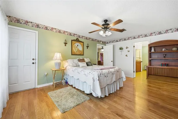 a bedroom with a large bed and a window