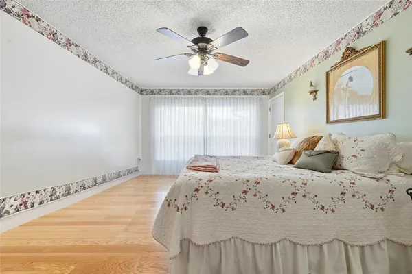 a bathroom with a granite countertop sink mirror vanity and toilet