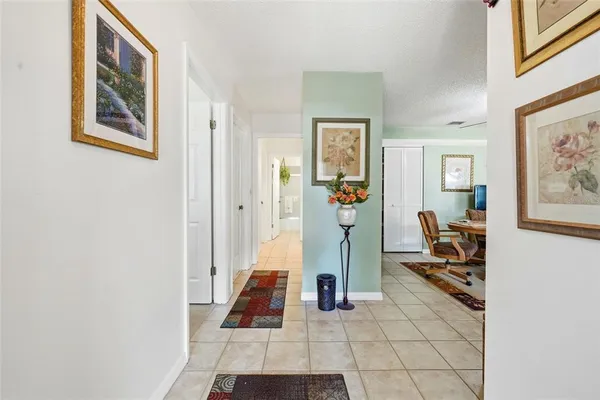 a hall way with furniture and wooden floor