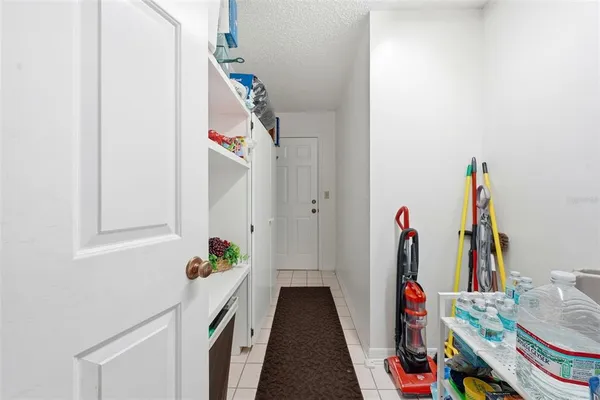 a view of hallway with stairs and a window