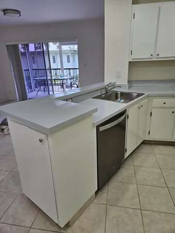 a kitchen with cabinets and window