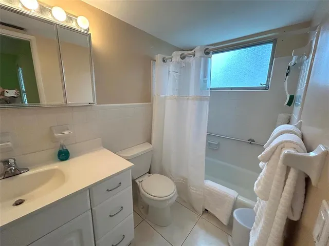 a view of a dining room with a table and chairs