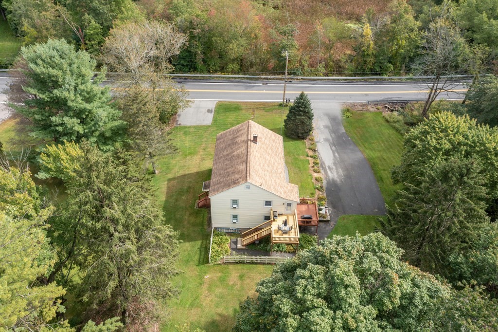 46 Sutton Road, Unit A Millbury, MA 01527 - Photo 2 of 14 an aerial view of a house with swimming pool and large trees