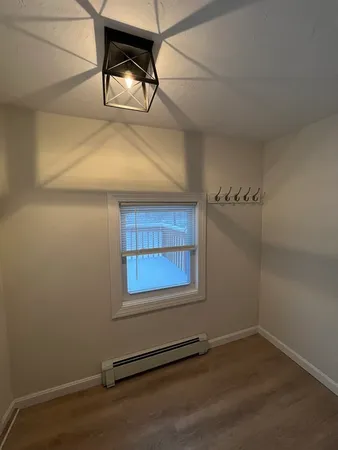 a view of an empty room and wooden floor