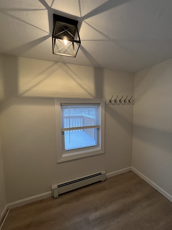 46 Sutton Road, Unit A Millbury, MA 01527 - Photo 5 of 14 a view of an empty room and wooden floor