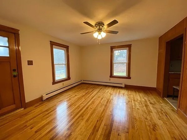 46 Sutton Road, Unit A Millbury, MA 01527 - Photo 8 of 14 a view of empty room with wooden floor and fan