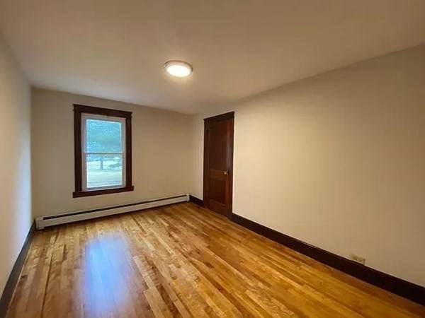 46 Sutton Road, Unit A Millbury, MA 01527 - Photo 10 of 14 a view of an empty room with wooden floor and a window