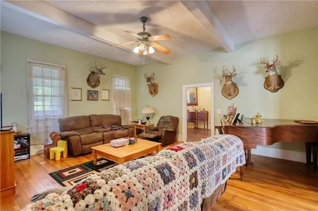 a living room with furniture and a wooden floor