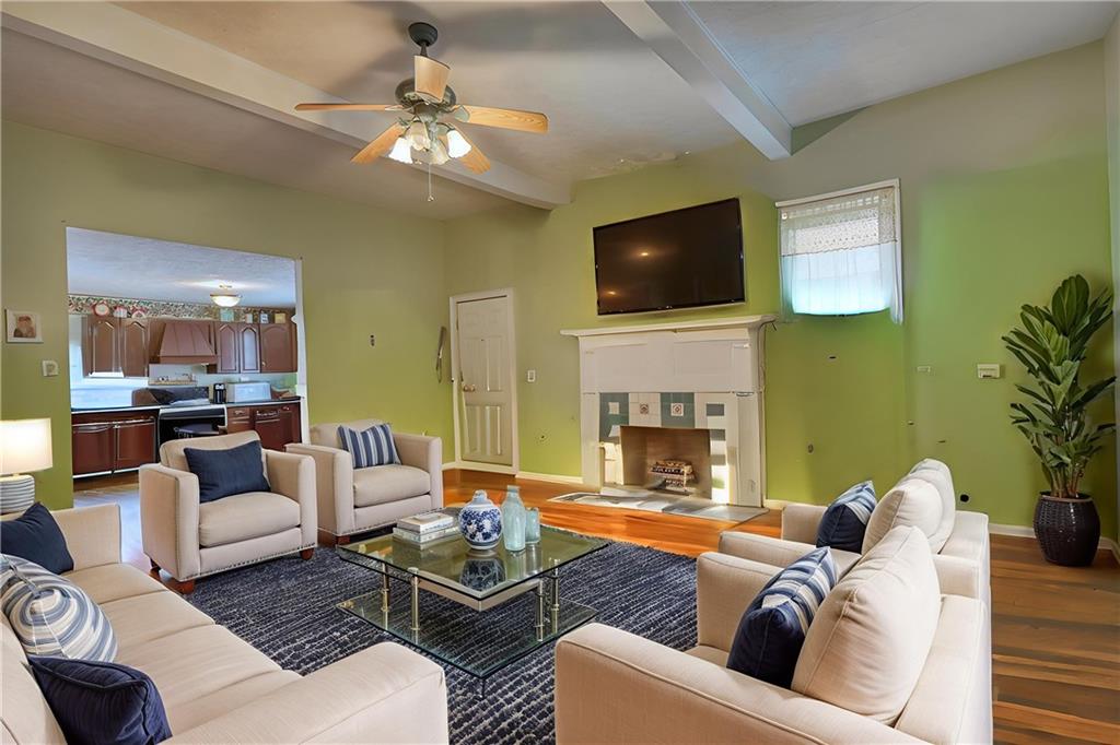5011 Penfield Road Union Point, GA 30669 - Photo 12 of 68 a living room with furniture and a fireplace
