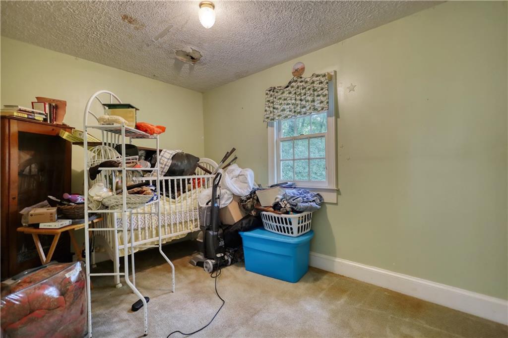 5011 Penfield Road Union Point, GA 30669 - Photo 20 of 68 a bedroom with furniture and a window