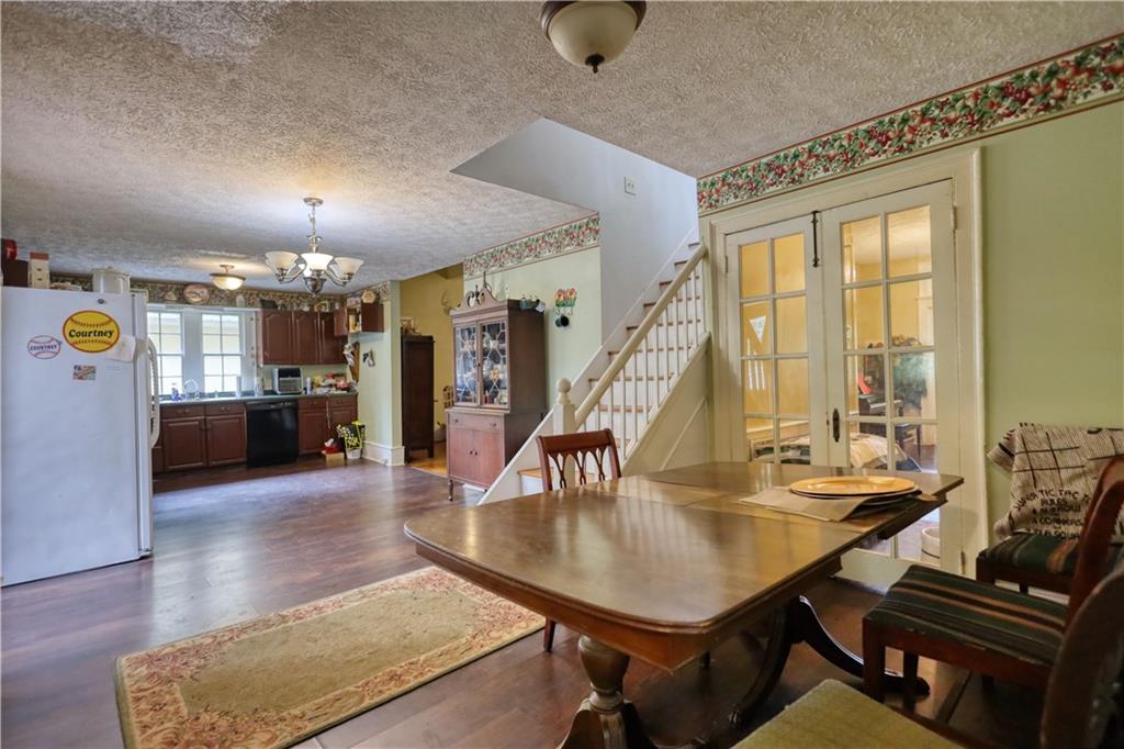 5011 Penfield Road Union Point, GA 30669 - Photo 23 of 68 a dining room with furniture and wooden floor