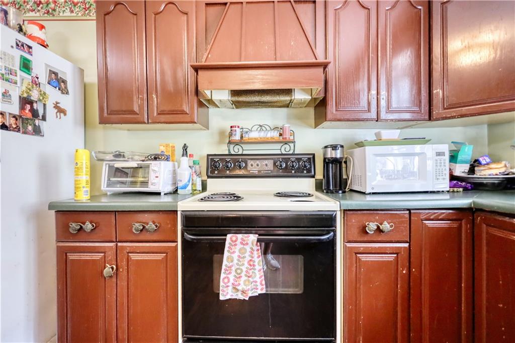 5011 Penfield Road Union Point, GA 30669 - Photo 26 of 68 a kitchen with stainless steel appliances granite countertop a stove and a microwave