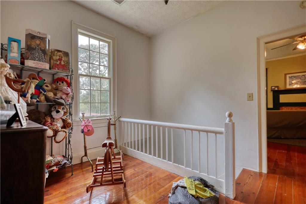 5011 Penfield Road Union Point, GA 30669 - Photo 31 of 68 a view of a livingroom with furniture entryway wooden floor and windows