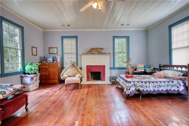 a bedroom with a bed and a potted plant
