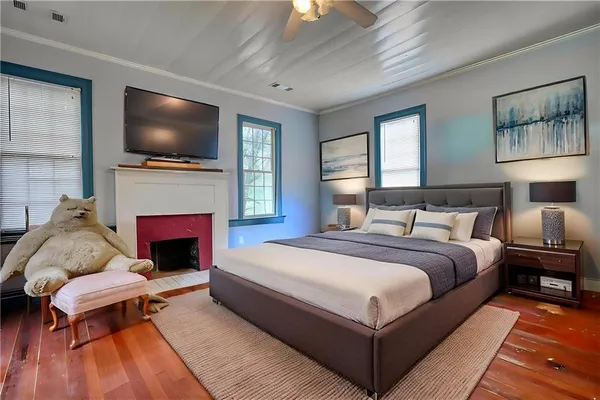 a bedroom with a bed and a potted plant
