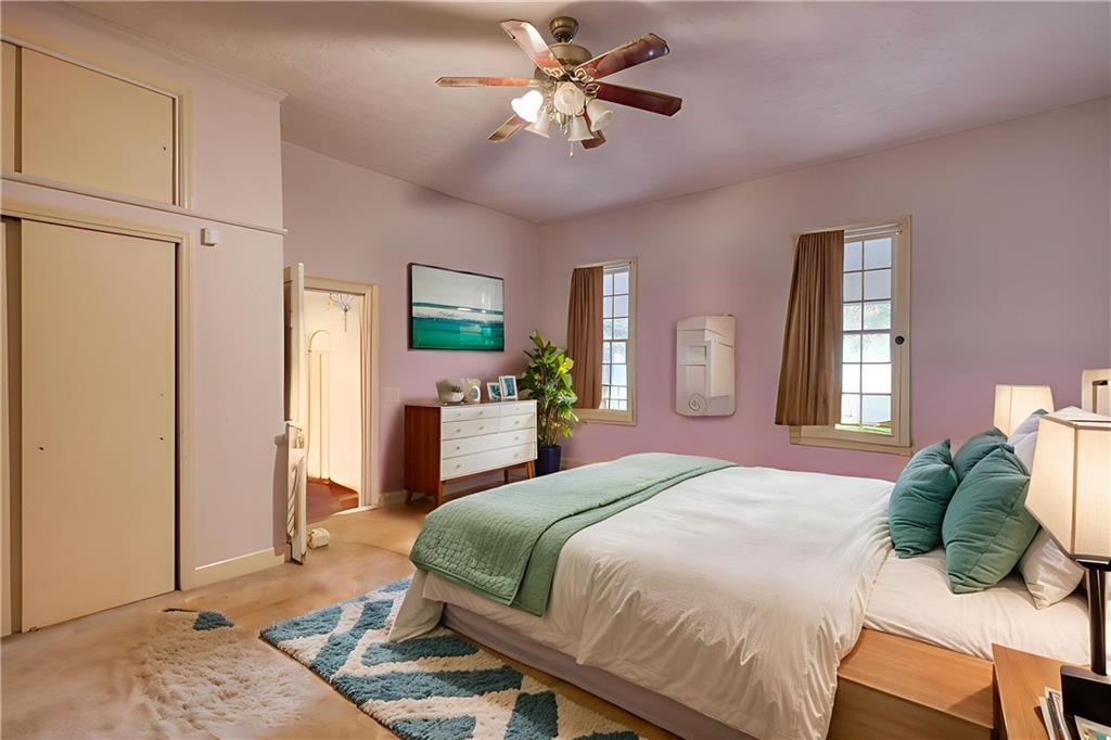 5011 Penfield Road Union Point, GA 30669 - Photo 37 of 68 a bedroom with a bed and a chandelier