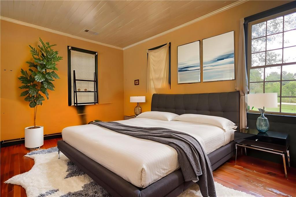 5011 Penfield Road Union Point, GA 30669 - Photo 39 of 68 a bedroom with a bed and a potted plant