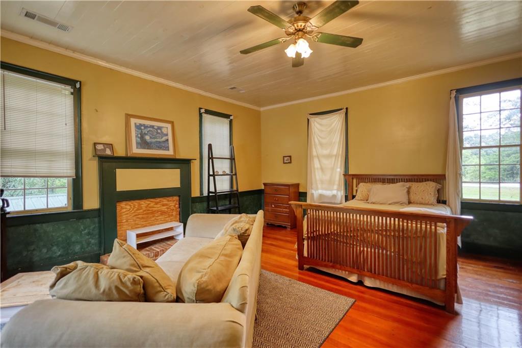 5011 Penfield Road Union Point, GA 30669 - Photo 42 of 68 a bedroom with a bed and wooden floor