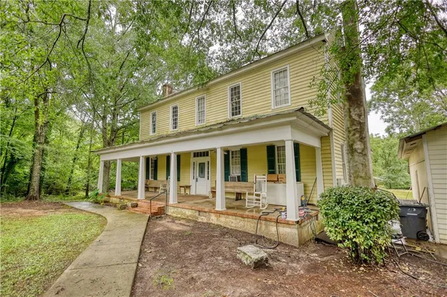 a front view of a house with a garden and patio