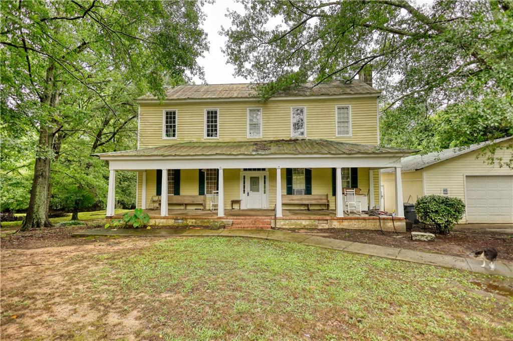 5011 Penfield Road Union Point, GA 30669 - Photo 8 of 68 a front view of a house with a yard