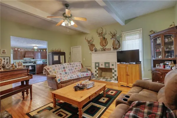 a living room with fireplace furniture and a chandelier