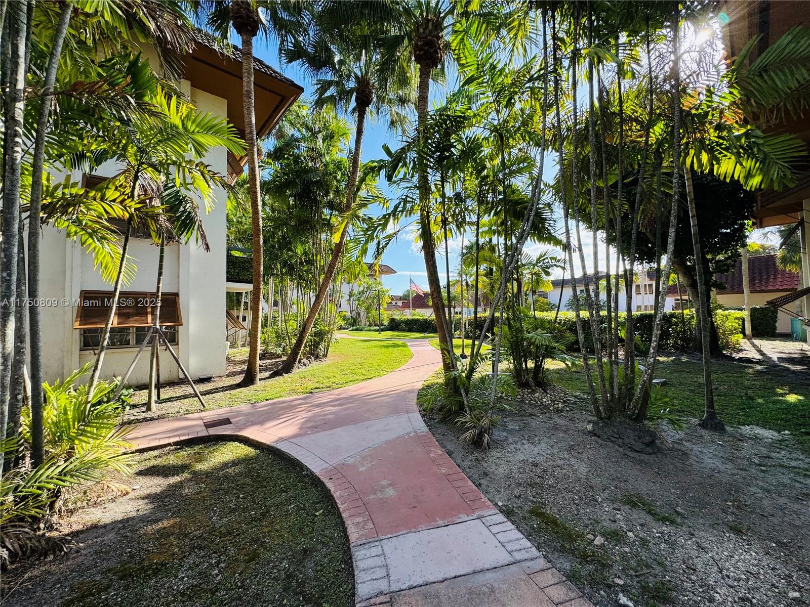9394 Southwest 77th Avenue, Unit F1 Miami, FL 33156 - Photo 19 of 24 a view of a swimming pool with a patio