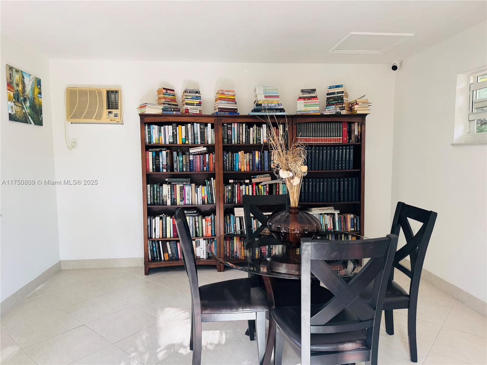 9394 Southwest 77th Avenue, Unit F1 Miami, FL 33156 - Photo 22 of 24 a view of a dining room with furniture and chandelier