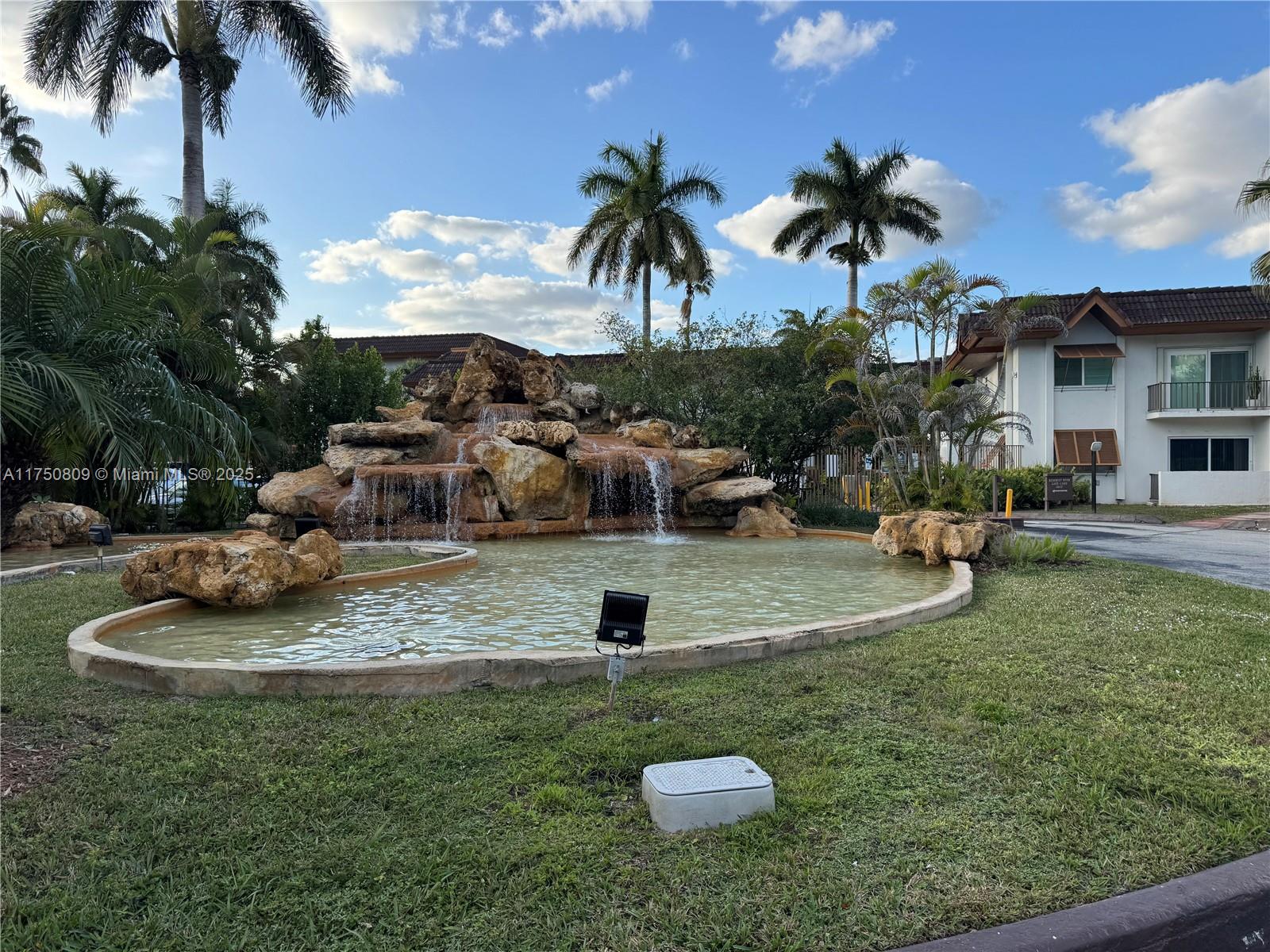 9394 Southwest 77th Avenue, Unit F1 Miami, FL 33156 - Photo 23 of 24 a view of a garden with a slide
