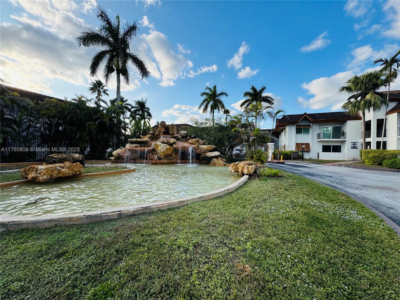 9394 Southwest 77th Avenue, Unit F1 Miami, FL 33156 - Photo 24 of 24 a view of a yard with cars