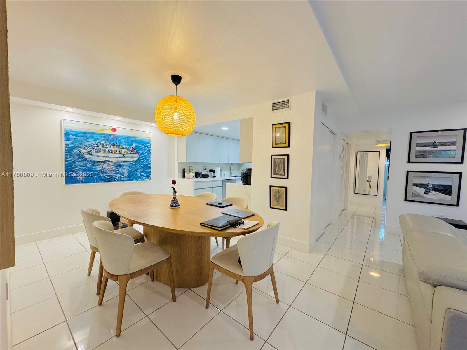 9394 Southwest 77th Avenue, Unit F1 Miami, FL 33156 - Photo 5 of 24 a view of a table and chairs in the kitchen