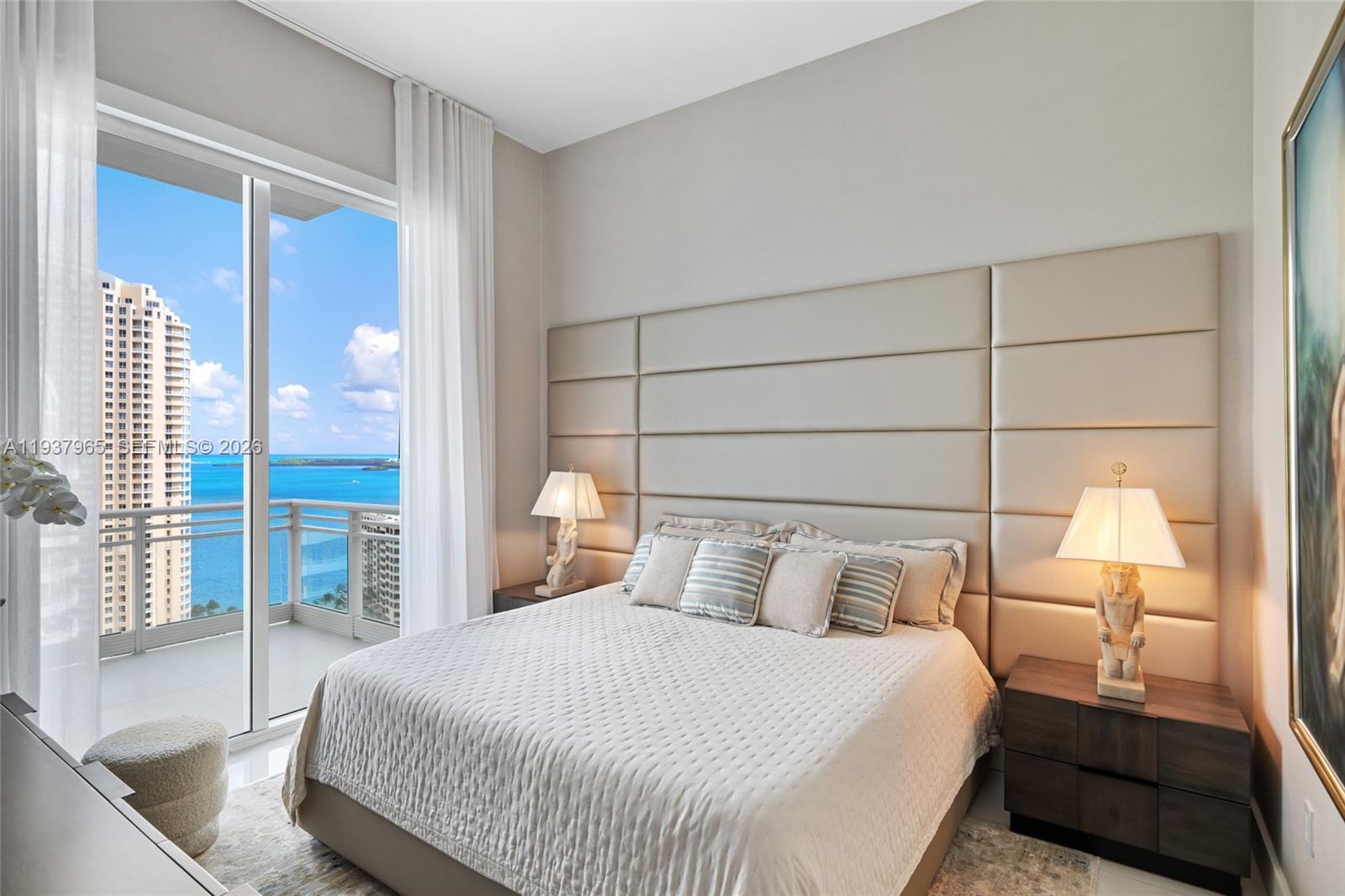 900 Brickell Key Boulevard, Unit 2004 Miami, FL 33131 - Photo 24 of 35 a bedroom with a bed and a large window