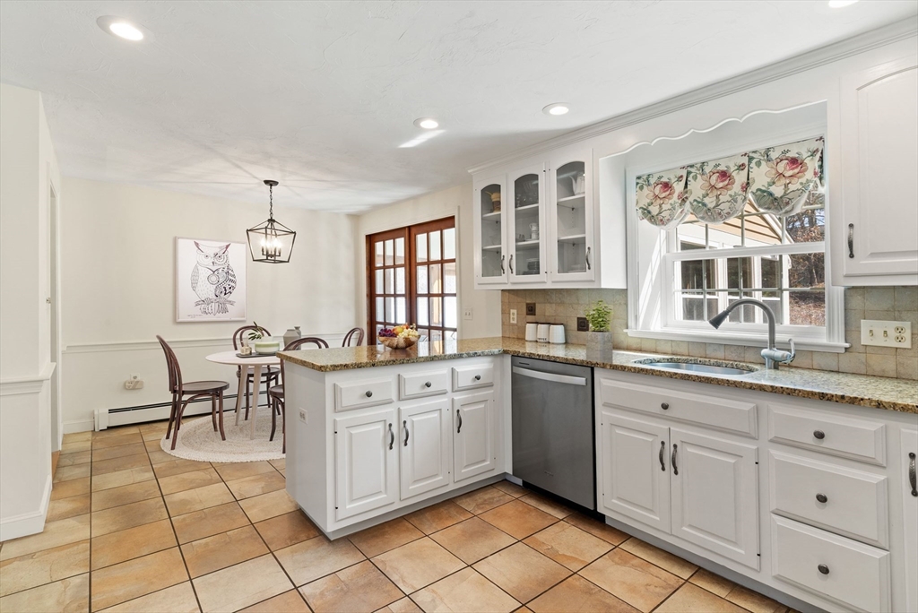 21 Worcester Road Norfolk, MA 02056 - Photo 11 of 40 a kitchen with stainless steel appliances granite countertop a sink and cabinets