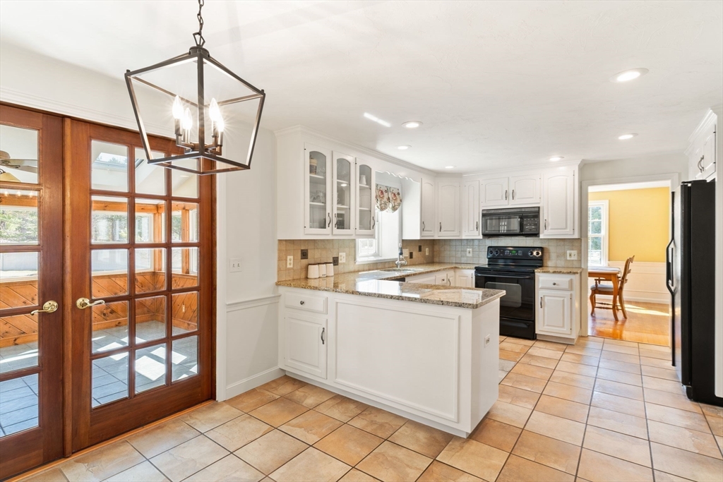 21 Worcester Road Norfolk, MA 02056 - Photo 12 of 40 a kitchen with stainless steel appliances a stove refrigerator sink and cabinets