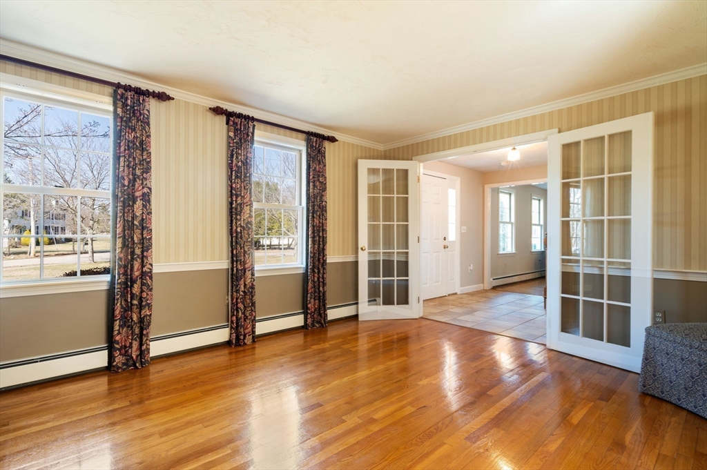 21 Worcester Road Norfolk, MA 02056 - Photo 16 of 40 a view of an empty room with wooden floor and a window