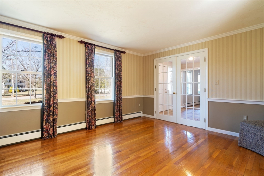 21 Worcester Road Norfolk, MA 02056 - Photo 17 of 40 a view of an empty room with wooden floor and a window