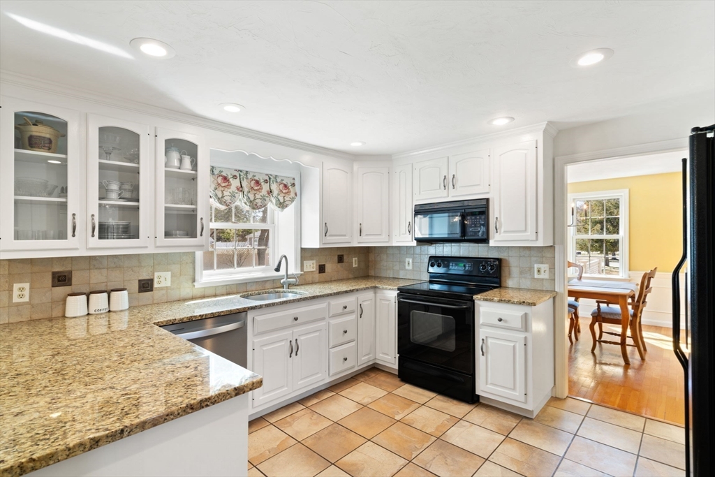 21 Worcester Road Norfolk, MA 02056 - Photo 8 of 40 a kitchen with stainless steel appliances granite countertop a stove top oven a sink dishwasher and a refrigerator