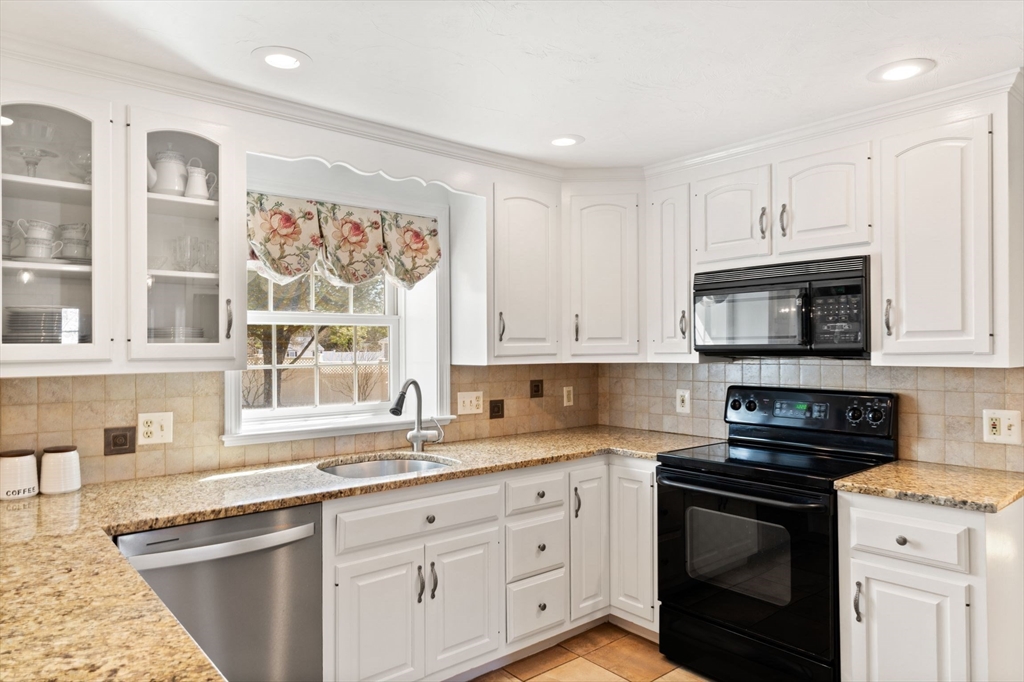 21 Worcester Road Norfolk, MA 02056 - Photo 9 of 40 a kitchen with granite countertop white cabinets stainless steel appliances and a sink