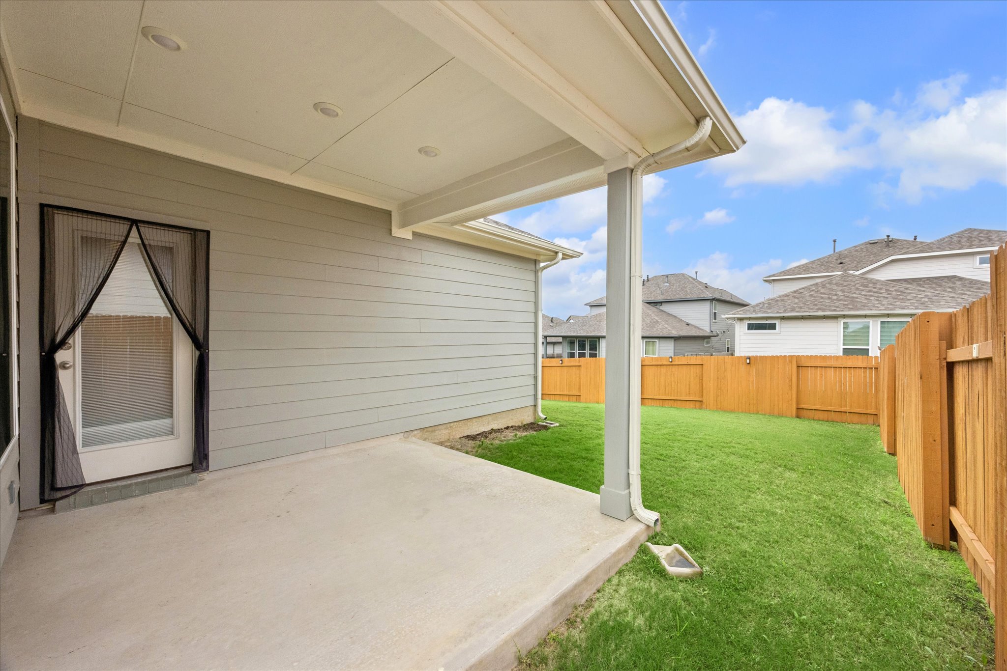 6407 Rounded Pebble Lane Buda, TX 78610 - Photo 29 of 32 A compact private yard with a covered patio for outdoor enjoyment.