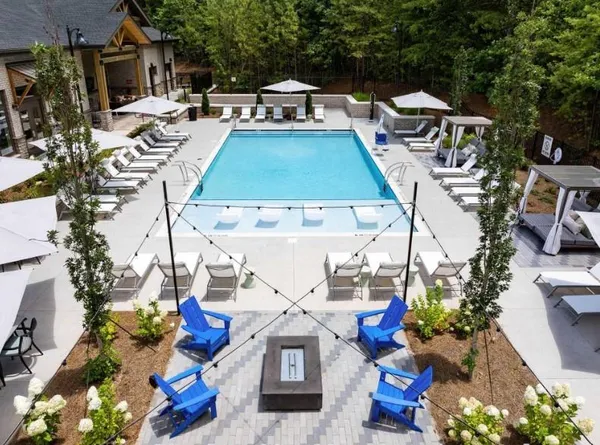a view of a house with swimming pool and sitting area