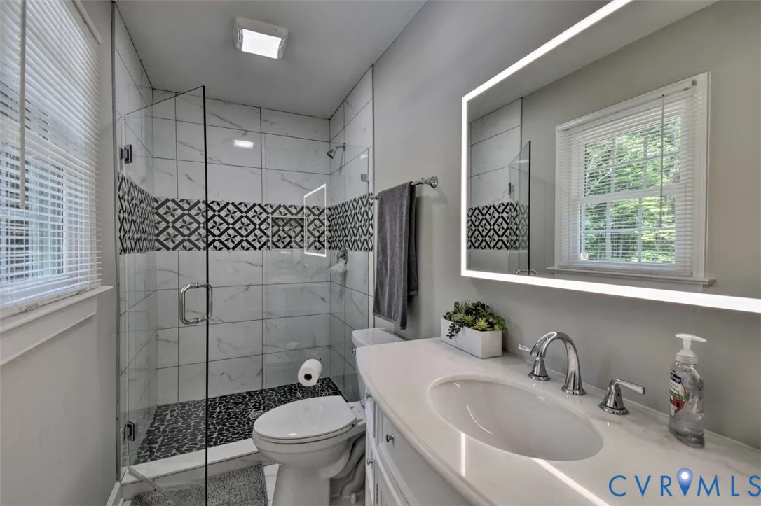 5180 Bemiss Road Richmond, VA 23234 - Photo 13 of 31 a bathroom with a sink toilet and shower